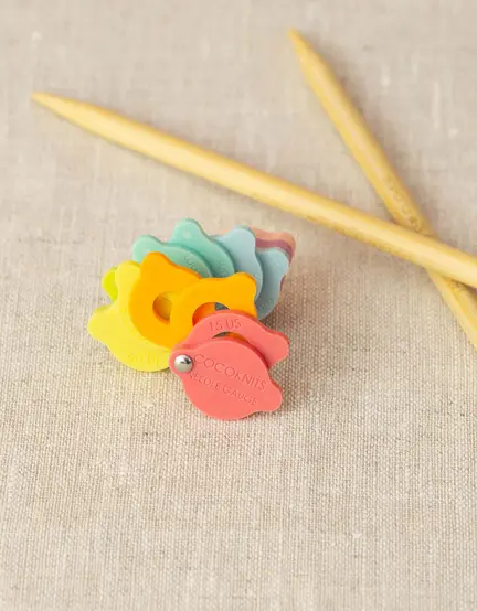 CocoKnits Pindemåler ved siden af strikkepinde