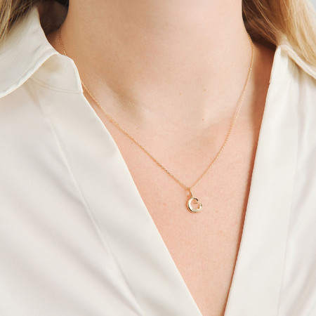 Ocean Petite pendant in 14-carat gold, as shown on the model