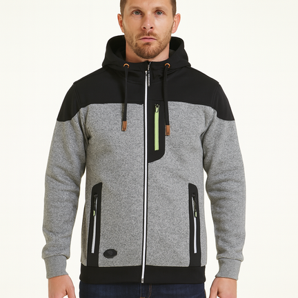 Mand bærer grå og sort herrejakke med aftagelig hætte og orange lynlåse