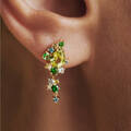 Model wearing FOUR SEASONS SPRING earrings in 14 karat gold with genuine stones: peridot, blue apatite, London blue topaz, green sapphire, tsavorite and green tourmaline