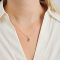 Four Seasons Spring Petite pendant in 14-carat gold, as worn by the model