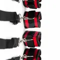 Black and red wrist and ankle bed restraint with adjustable straps