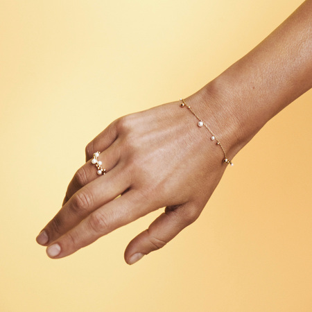 Model wearing BUBBLES N' PEARLS ring in 14 karat gold with cultured pearls.