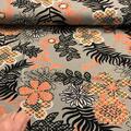 Bomuldsjersey med blomster print i orange og sort.
