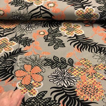 Bomuldsjersey med blomster print i orange og sort.