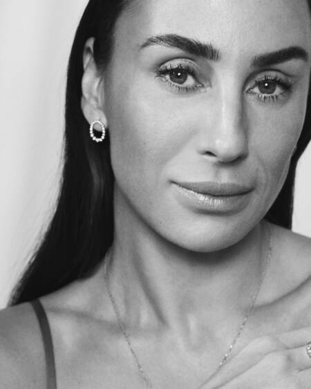 Medina wearing AURORA'S KISS earrings in silver with white topaz.