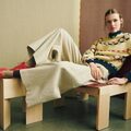 model sidder paa stol ifoert helga isagers sweater gunta sweater i gul version med isager soft