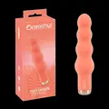 Peachy! Mini Beads vibrator i coral-pink med bølget form – kompakt og kraftfuld.