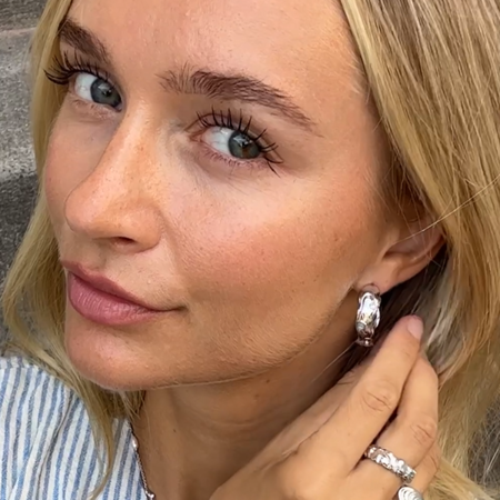 Asta wearing Shell hoops made in 925 sterling silver with zirconia.