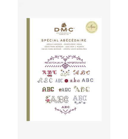 forside paa bog fra dmc med broderimoenstre temaet bogstaver med mange broderede bogstaver paa forsiden