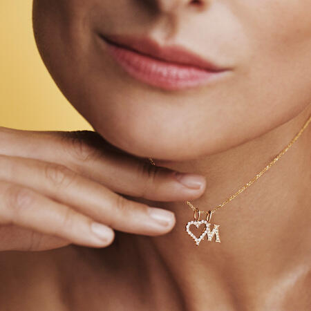 Model wearing the TENDER LOVE M pendant in 14 karat gold with 0.085 ct. W.SI diamonds.