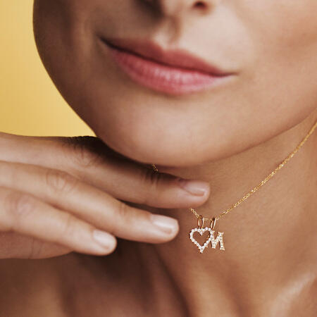 Model wearing TENDER LOVE M pendant in 14 karat gold with 0.085 ct. W.SI diamonds.