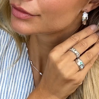 Asta wearing Shell ring made in 925 pure sterling silver with green zirconia.