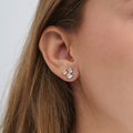 Fleur earrings in sterling silver with 14-carat gold detailing, worn by a model