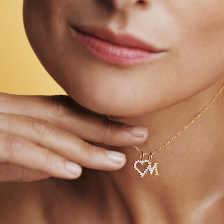 Model wearing TENDER LOVE M pendant in 14 karat gold with 0.085 ct. W.SI diamonds.