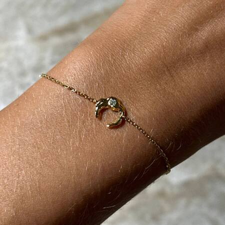 Lunar bracelet made in 925 sterling silver plated with 18 karat gold set with green zirconia.