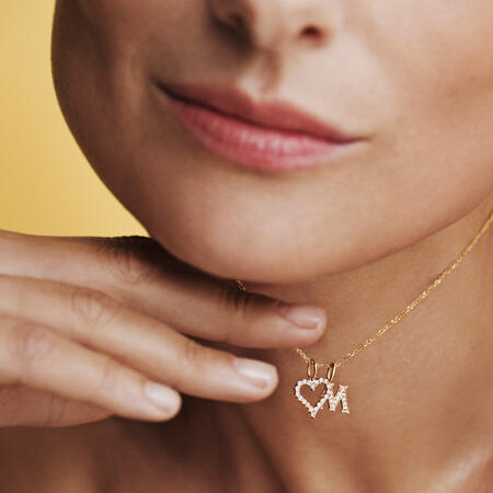 Model wearing TENDER LOVE M pendant in 14 karat gold with 0.085 ct. W.SI diamonds.